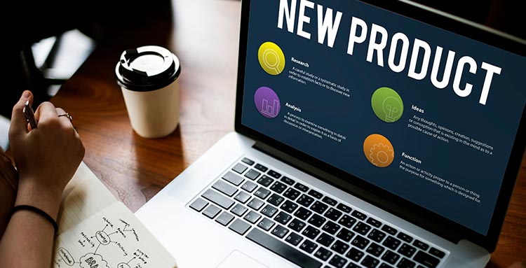 Ein aufgeklappter Laptop auf einem Schreibtisch, im Screen sichtbar steht New Produkt in unserem Online Marketing Coaching.