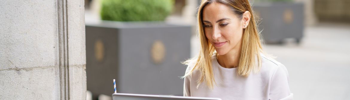 Frau sitzt nachdenklich vor Laptop